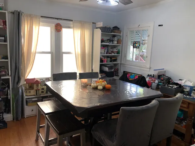 a view of a dining room with furniture and window