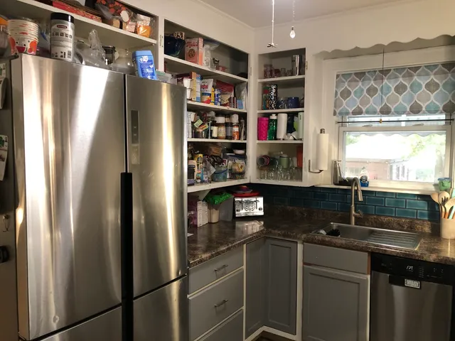 a kitchen with stainless steel appliances a refrigerator and a sink