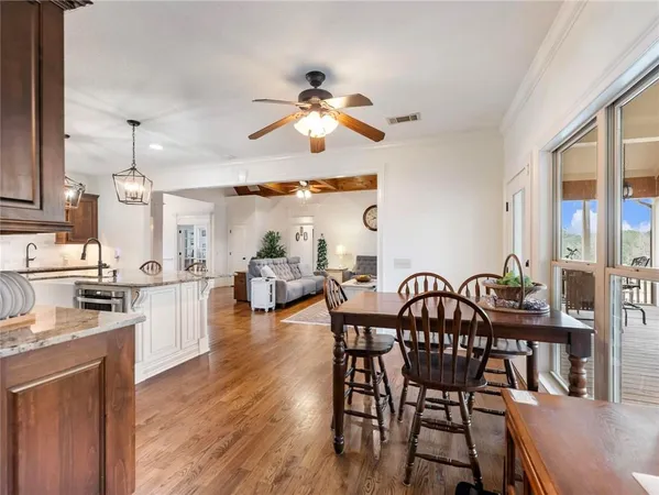 a bedroom with a bed a dresser and potted plants