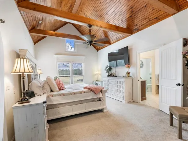 a bathroom with a granite countertop sink a toilet and shower