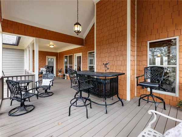 a spacious bedroom with a large bed and a chandelier