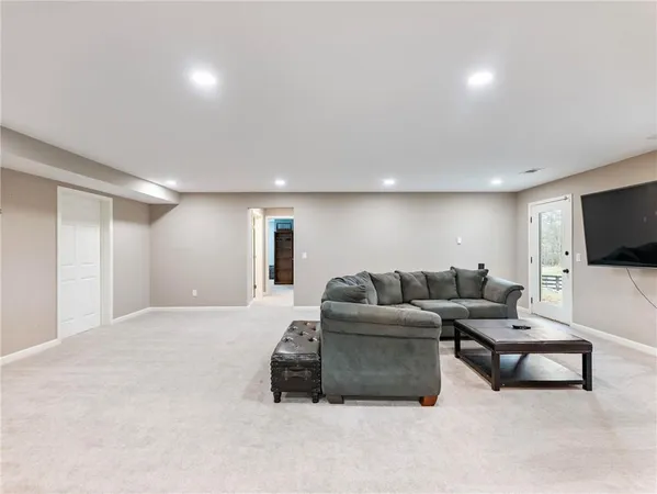 a front view of a house with a yard covered with snow