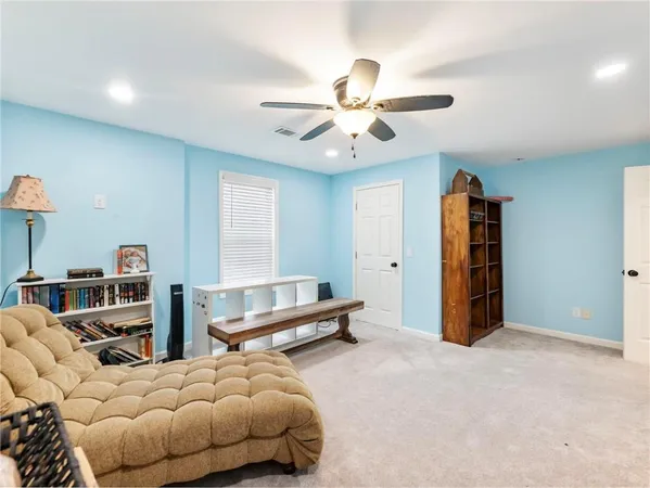 a view of a swimming pool with a lawn chairs and a fire pit