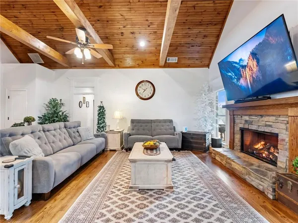 a kitchen with stainless steel appliances granite countertop a sink a stove and a wooden floors