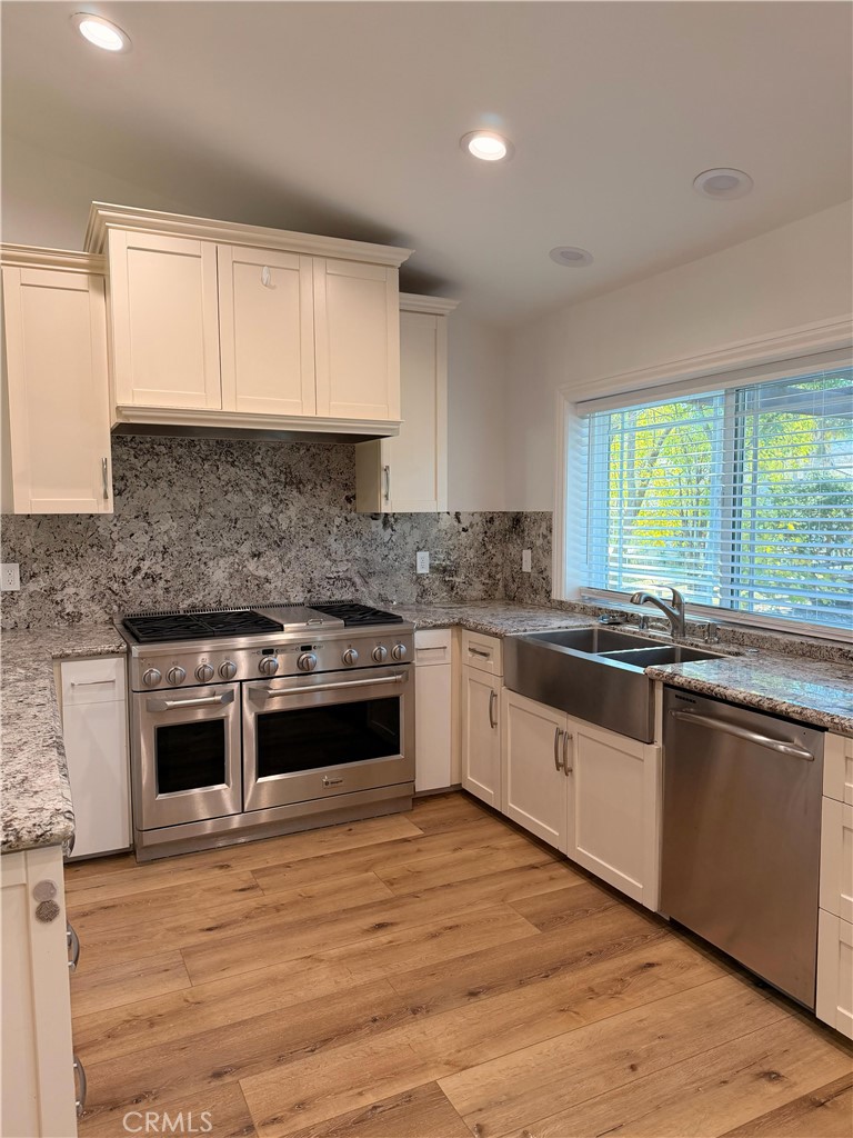 5365 Lewis Road Agoura Hills, CA 91301 - Photo 4 of 21 a kitchen with granite countertop white cabinets and white appliances
