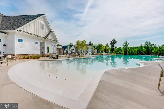 a view of a house with a yard and a large tree
