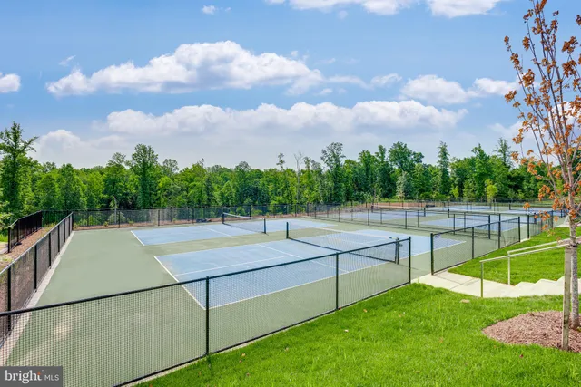 a view of a patio with a table and chairs and potted plants