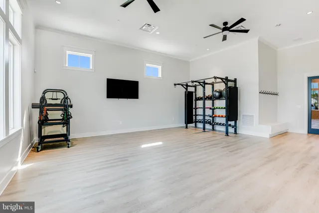 a view of a kitchen with kitchen island a sink wooden floor and a large window