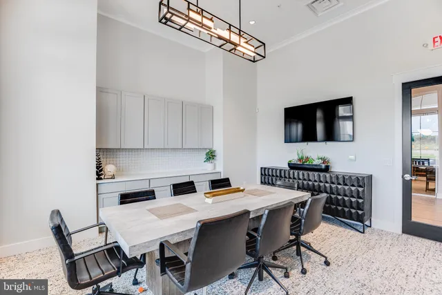 a large kitchen with a sink and chandelier