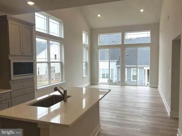 a large white kitchen with wooden floors
