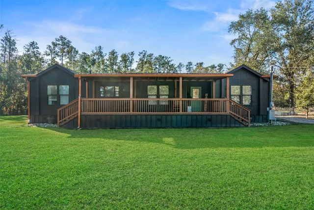 a view of a house with a yard and a garden