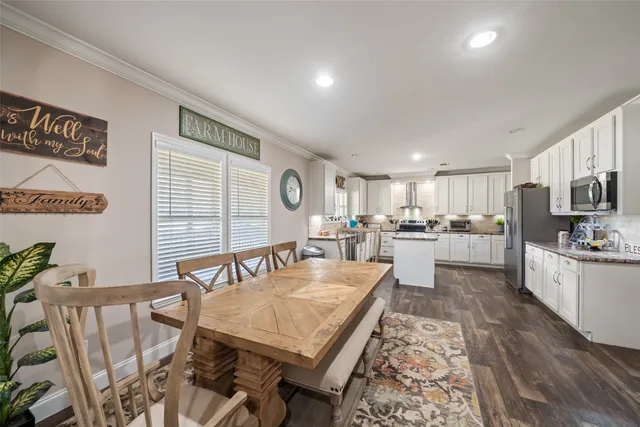 a living room with stainless steel appliances kitchen island granite countertop furniture and a kitchen view