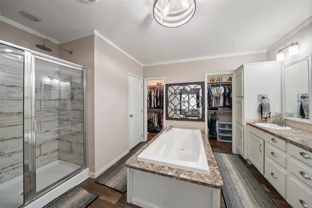 a large spacious bathroom with a granite countertop sink a mirror and a shower
