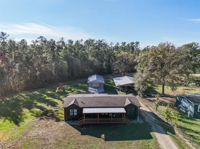 an aerial view of a house with a yard