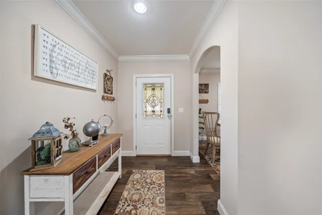a hallway with front door wooden floor and windows