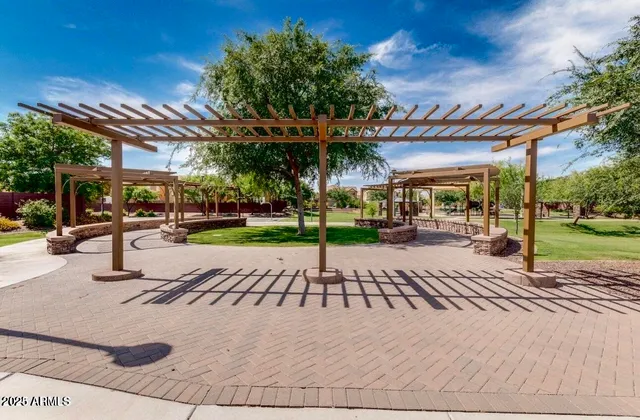 a view of a park with swings on the side of building