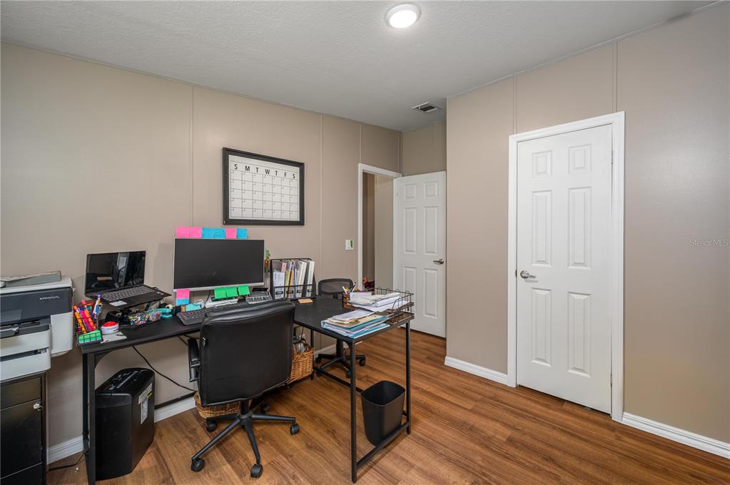 15079 Brahma Road Polk City, FL 33868 - Photo 21 of 40 a view of a workspace with furniture and wooden floor