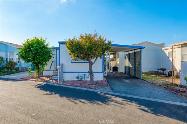 a view of a house with backyard and sitting area