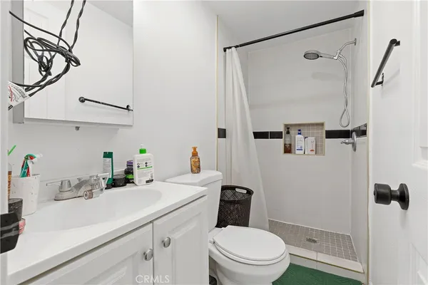 a bathroom with a toilet sink and a mirror