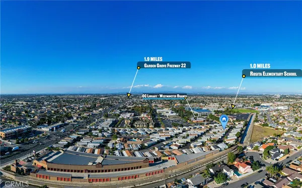 a view of a swimming pool with a patio and dining table