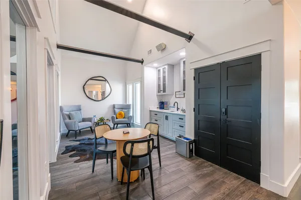 a dining room with a wooden table and chairs