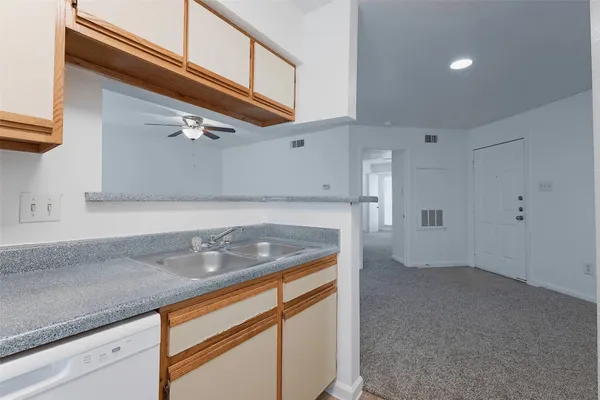 a kitchen with granite countertop a sink and cabinets