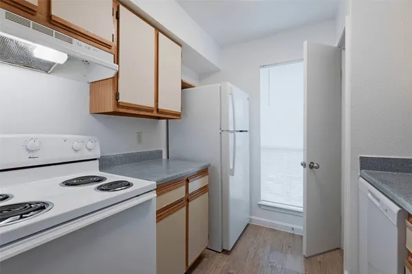 a kitchen with stainless steel appliances granite countertop a refrigerator and a stove