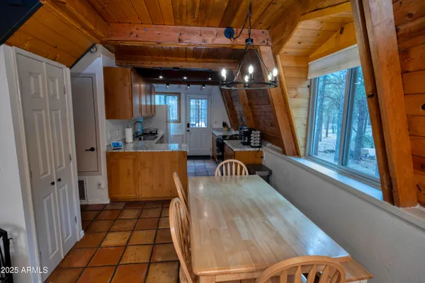 a kitchen with a stove and a white wooden cabinets