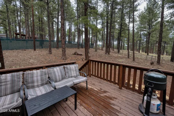 a view of a wooden deck with furniture