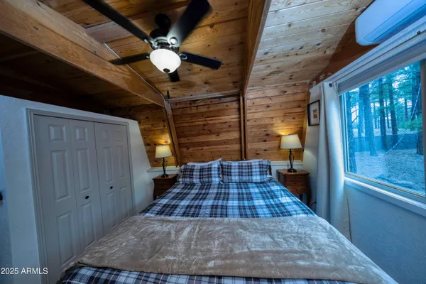 a bedroom with a bed dresser and a window