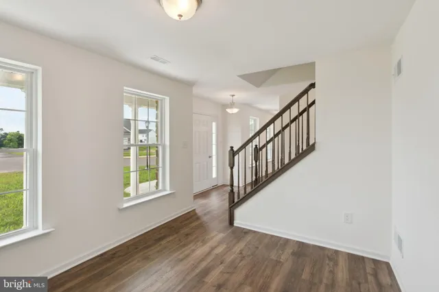 a view of an entryway with wooden floor and windows