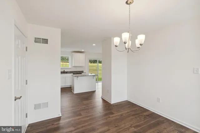 a view of a kitchen with a white cabinet and a fireplace