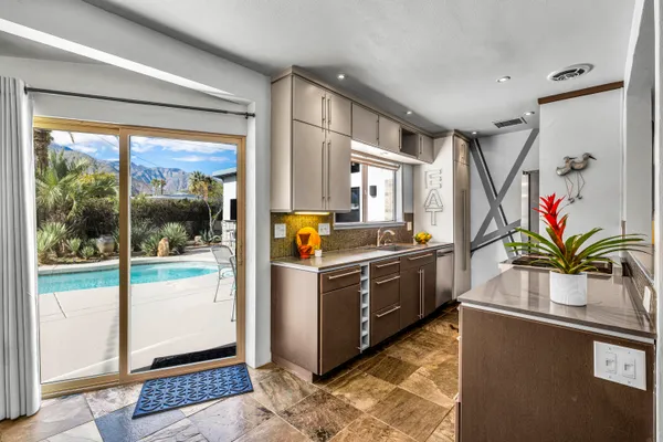 a kitchen with stainless steel appliances granite countertop a stove a sink and a granite counter tops