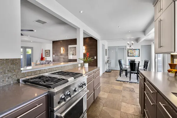 a kitchen with stainless steel appliances granite countertop a stove a sink dishwasher and cabinets