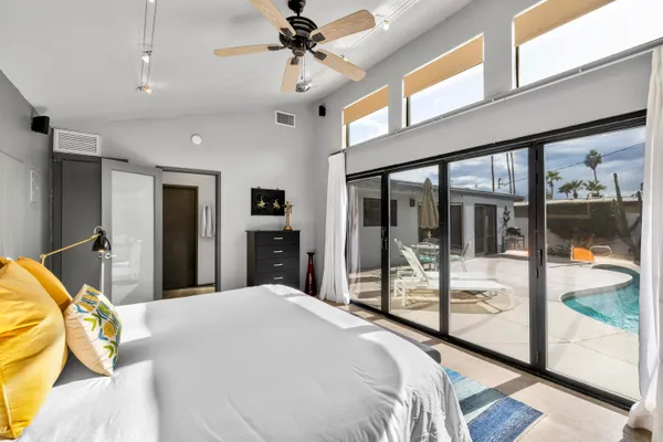 a bedroom with a bed and a night stand