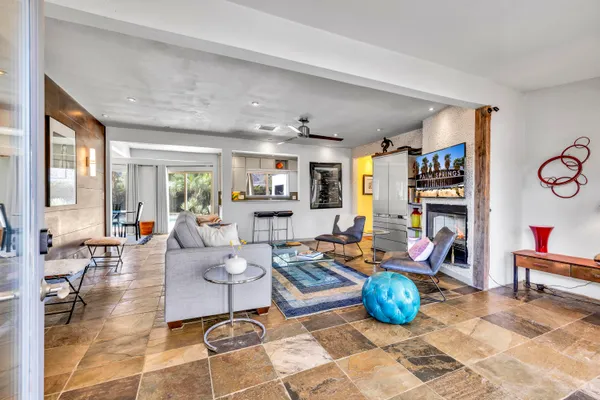 a living room with furniture a rug and a window