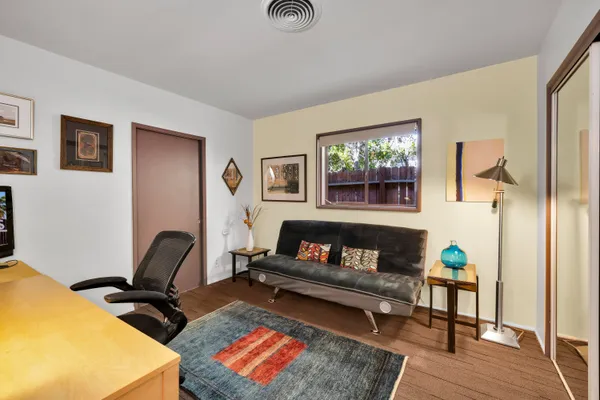 a living room with furniture and wooden floor