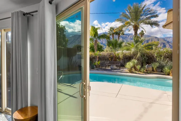 a swimming pool with outdoor seating and yard