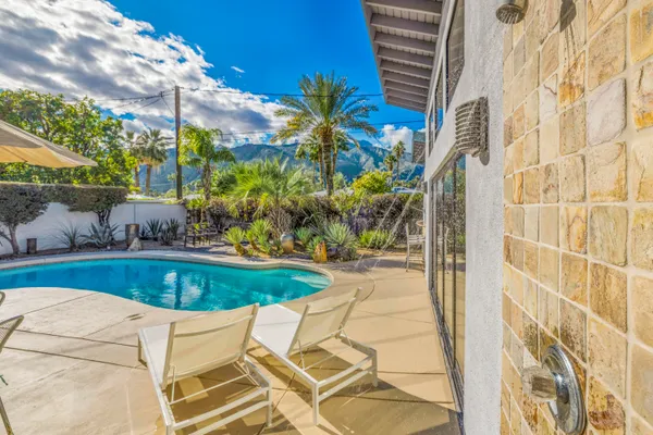 a view of a swimming pool with a yard