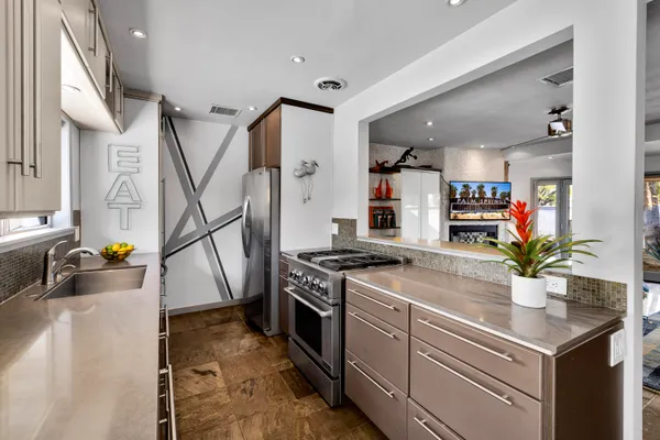 a kitchen that has a sink and a stove in it