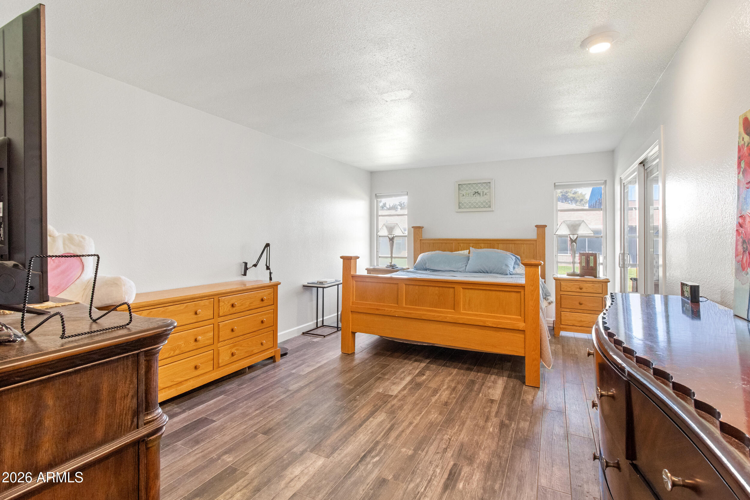 9801 West Pleasant Valley Road Sun City, AZ 85351 - Photo 14 of 26 a bedroom with furniture and wooden floor