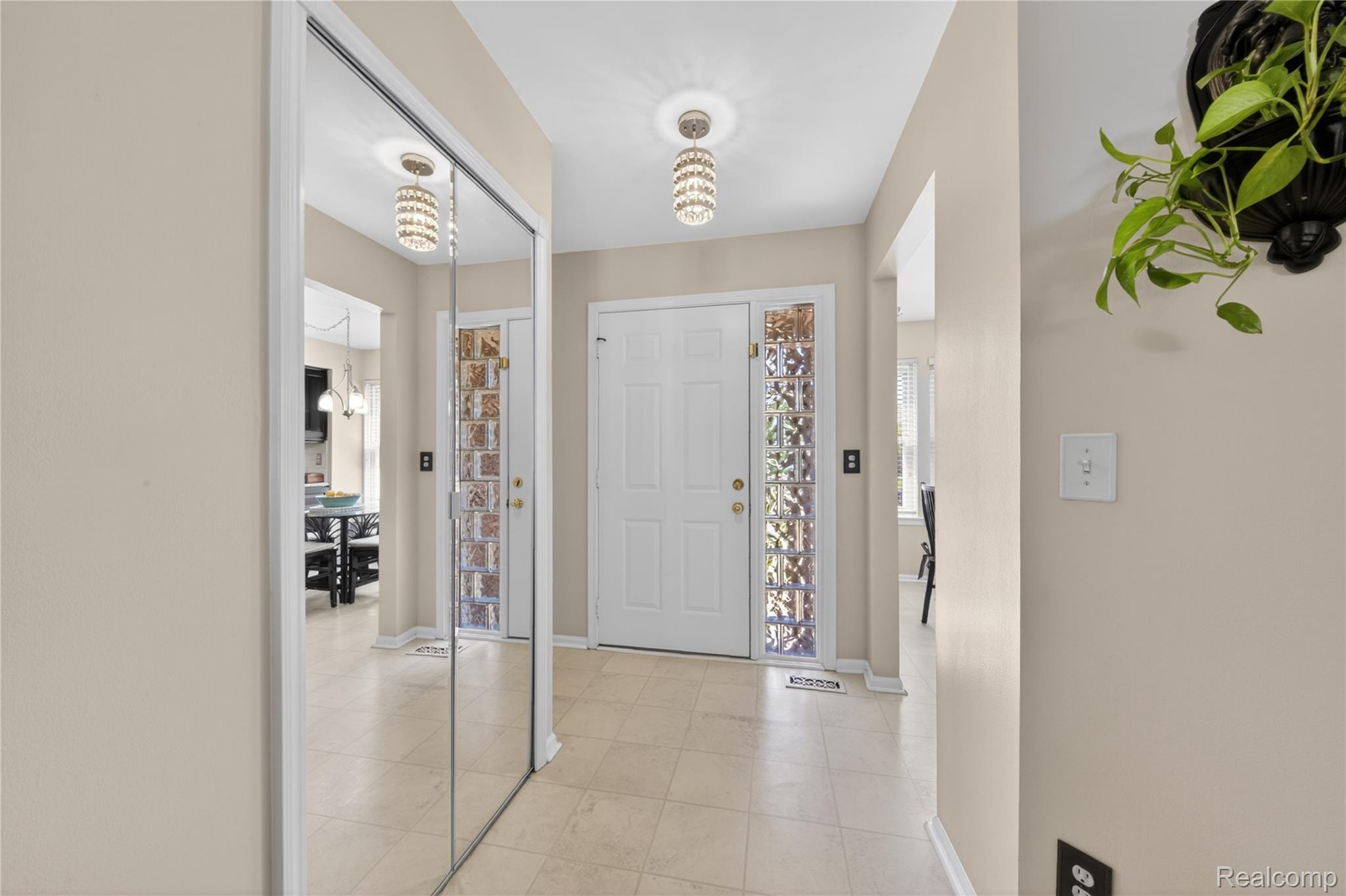44570 Ridgefield Road Canton, MI 48188 - Photo 4 of 31 Foyer with neutral wall tones, tile flooring, glass block sidelights, and a mirrored closet door