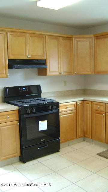 1807 Laurel Terrace Lake Como, NJ 07719 - Photo 3 of 9 a kitchen with stainless steel appliances granite countertop a stove a sink and a microwave