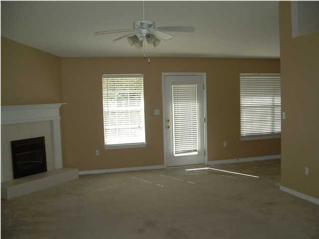 286 Beacon Way Santa Rosa Beach, FL 32459 - Photo 3 of 11 an empty room with a fireplace and windows