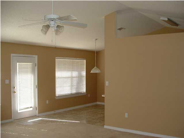 286 Beacon Way Santa Rosa Beach, FL 32459 - Photo 4 of 11 an empty room with windows and fan