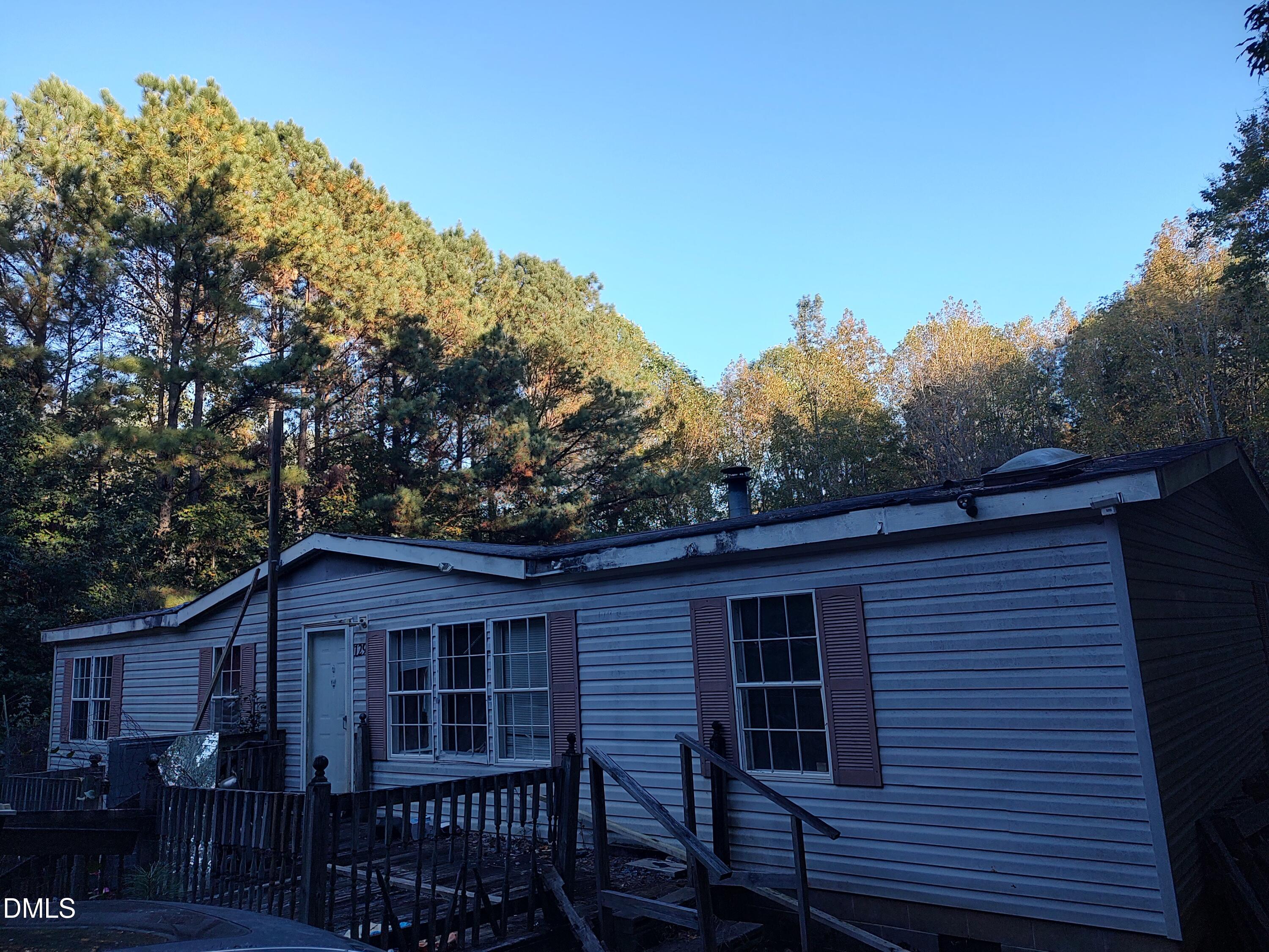129 Chestnut Drive Warrenton, NC 27589 - Photo 2 of 5 a view of a house with a yard