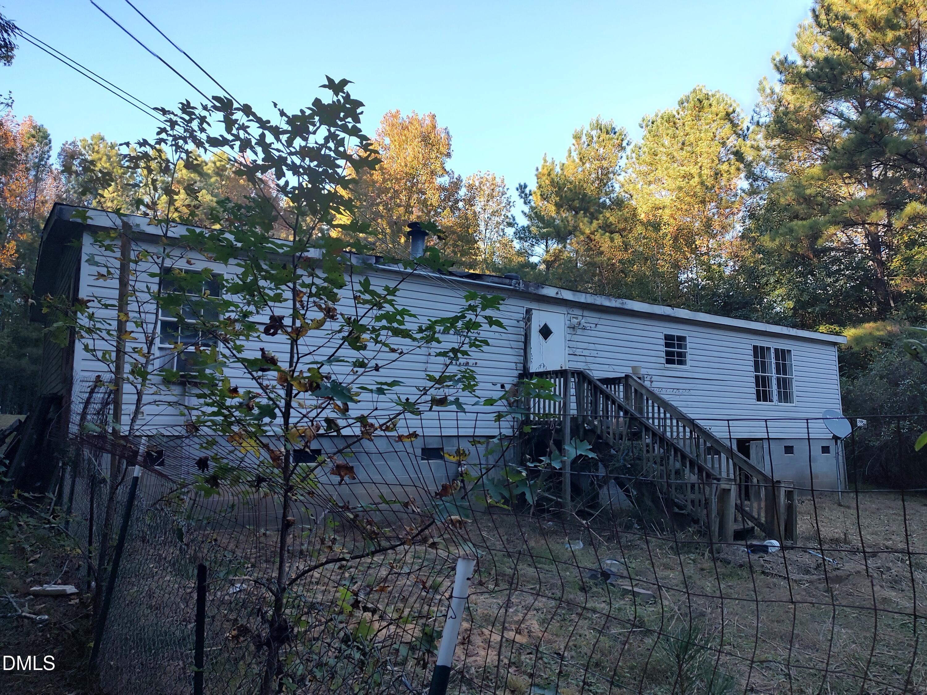 129 Chestnut Drive Warrenton, NC 27589 - Photo 5 of 5 a view of a house with a tree in the background