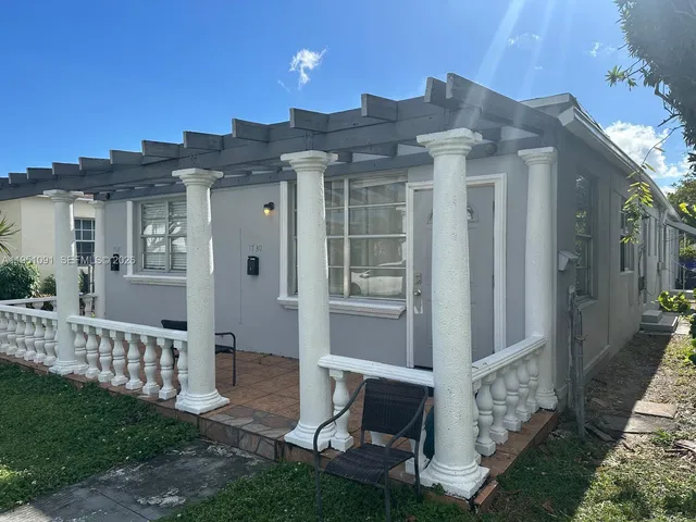 a view of a house with wooden fence