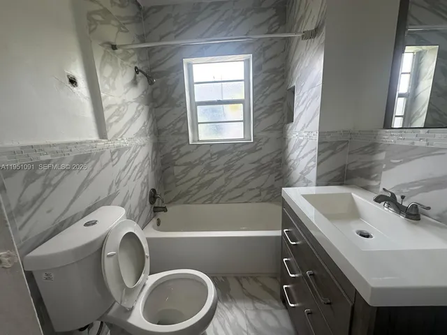 a bathroom with a sink a toilet and bathtub