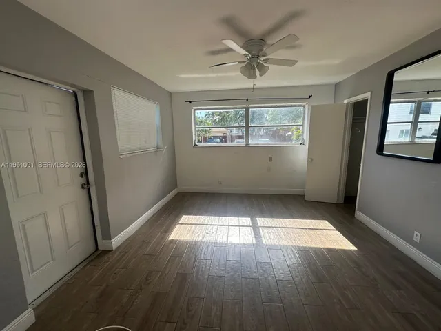 wooden floor in an empty room with a window